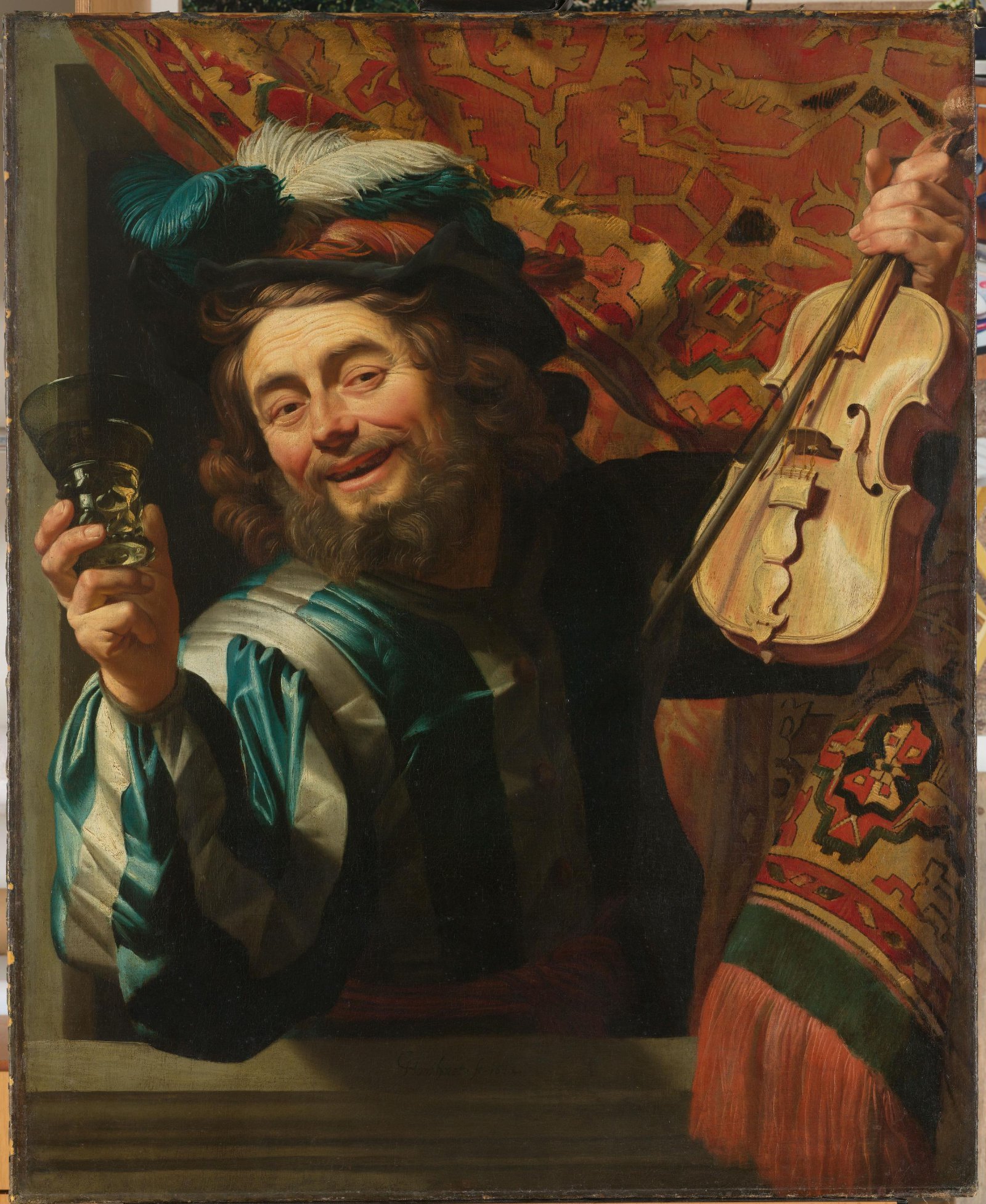 A laughing seventeenth-century violinist holds a violin and bow in one hand and raises a wineglass in the other in Gerard van Honthorst’s painting The Merry Fiddler.