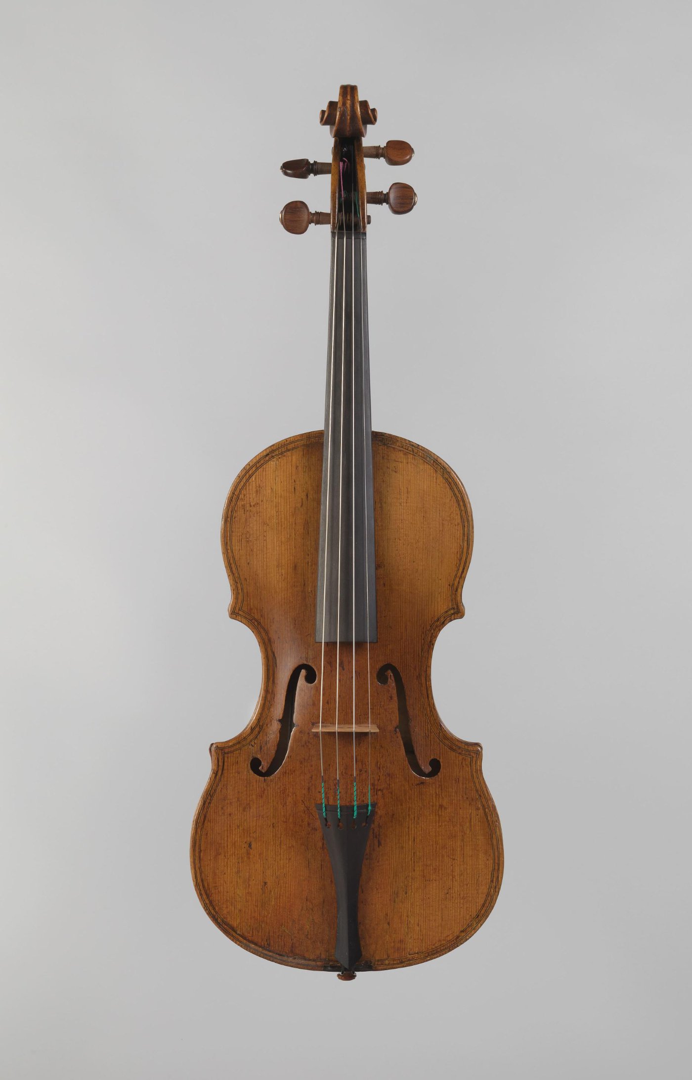 Full front view of a c. 1610 violin by Giovanni Paolo Maggini, showing the broad Brescian outline, long f-holes, and characteristic edge treatment.